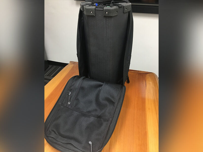 Office environment. Sitting on top of a wooden table is a set of radiation detection sensors (with carbon fiber enclosures) in an opened travel pack.